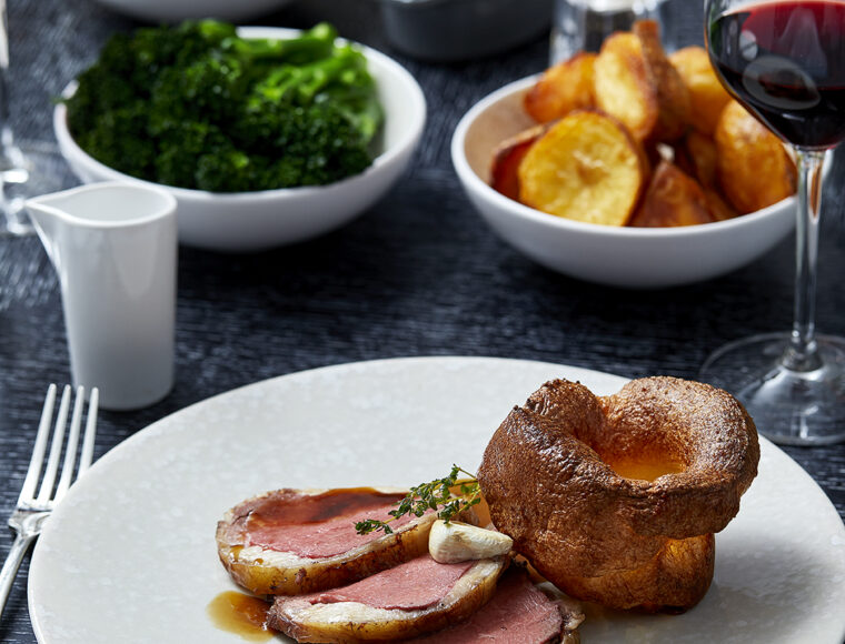 Roast beef Sunday lunch at Indigo Restaurant, One Aldwych in Covent Garden, with Yorkshire pudding, roast potatoes, seasonal vegetables and rich gravy.