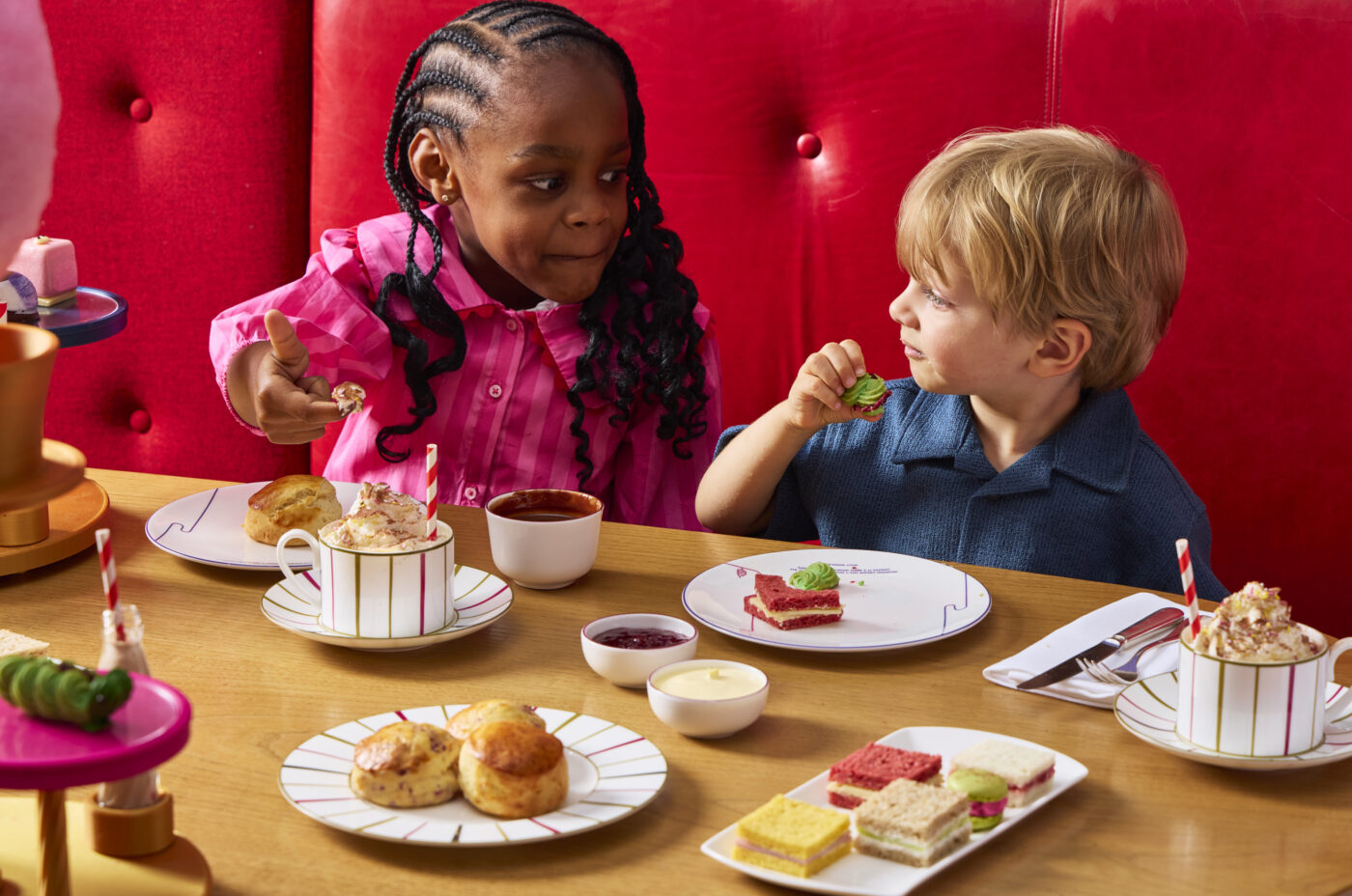 Children enjoying the Charlie and the Chocolate Factory Afternoon Tea at One Aldwych in Covent Garden, London, with imaginative themed desserts and sweet treats.