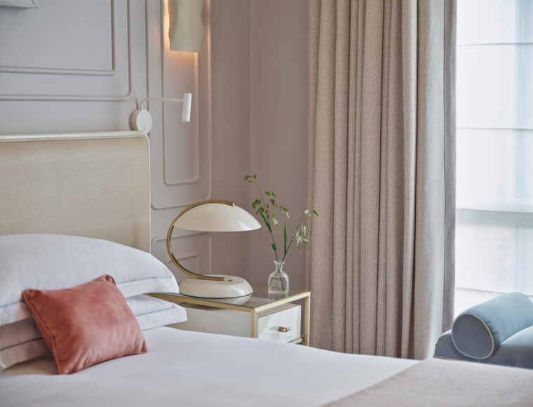 One Aldwych luxury hotel bedroom in London with elegant contemporary interiors, plush bed, and stylish furnishings.